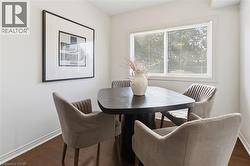 Dining space featuring baseboards and dark wood finished floors - 
