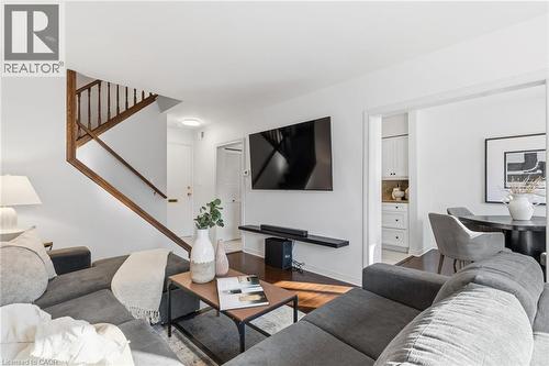 Living area with wood finished floors and stairway - 2069 Meadowbrook Road Unit# 4, Burlington, ON - Indoor Photo Showing Living Room