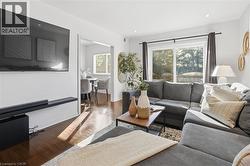 Living room with wood finished floors and recessed lighting - 