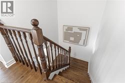 Staircase with wood finished floors and baseboards - 