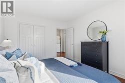 Bedroom featuring a closet and wood finished floors - 