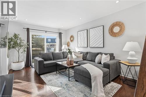 Living area featuring dark wood-style floors and recessed lighting - 2069 Meadowbrook Road Unit# 4, Burlington, ON - Indoor Photo Showing Living Room