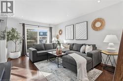 Living area featuring dark wood-style floors and recessed lighting - 