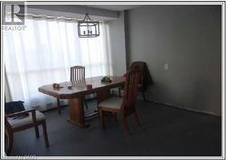 Dining room with carpet flooring and a chandelier - 