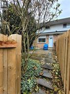 Fully fenced backyard with patio and mature landscaping. - 