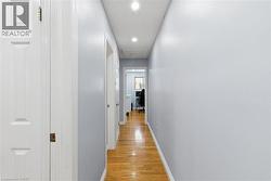 Corridor featuring light wood-style floors and recessed lighting - 