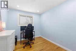 Office space with light wood-type flooring and recessed lighting - 