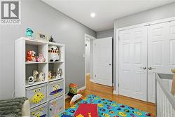 Recreation room featuring light wood-style floors and recessed lighting - 