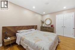 Bedroom featuring light wood-style floors, a closet, and recessed lighting - 