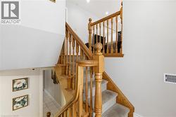 Stairway with tile patterned floors and recessed lighting - 