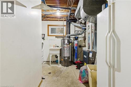 Unfinished below grade area featuring gas water heater and a water softener system - 364 Roselawn Place, Waterloo, ON - Indoor Photo Showing Basement