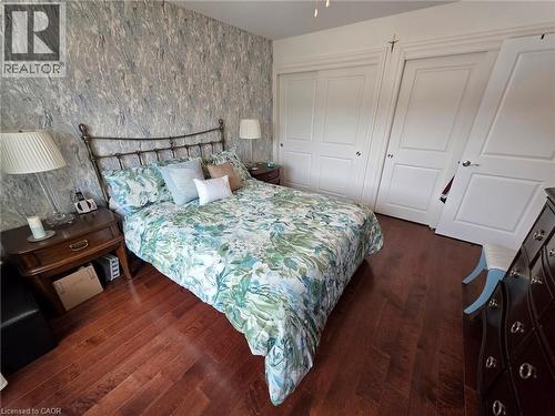 Bedroom with a closet and dark wood-style flooring - 49 Bishop Reding Trail, Hamilton, ON - Indoor Photo Showing Bedroom