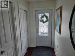 Doorway with wood finished floors and baseboards - 