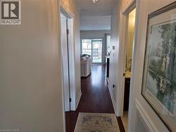Hallway featuring dark wood-type flooring and baseboards - 