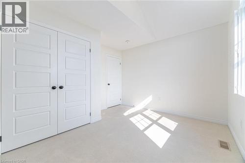 Unfurnished bedroom featuring light colored carpet and a closet - 28 Pickett Place, Cambridge, ON - Indoor Photo Showing Other Room