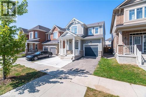 Craftsman inspired home with concrete driveway, covered porch, a garage, and stone siding - 28 Pickett Place, Cambridge, ON - Outdoor With Facade