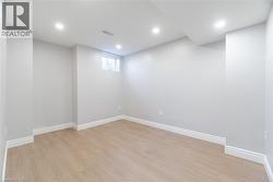 Below grade area with light wood-type flooring and recessed lighting - 