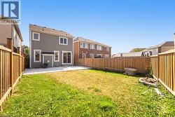 Rear view of property with a patio area, a fenced backyard, and a residential view - 