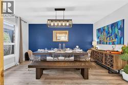 Dining room with an accent wall and wood finished floors - 