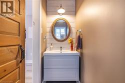 Bathroom with vanity and wood finished floors - 