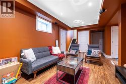 Living room with wood-type flooring, recessed lighting, and a raised ceiling - 