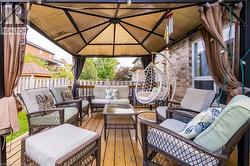 Deck with a gazebo and an outdoor living space - 