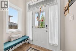 Entryway with light wood-style flooring and healthy amount of natural light - 