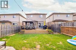 Back of property with a gazebo, a fenced backyard, and a deck - 