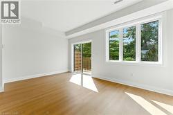 Spare room featuring baseboards and light wood-type flooring - 