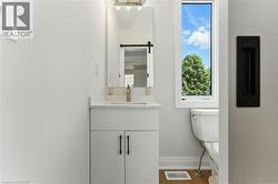 Half bath featuring vanity and light wood-style flooring - 