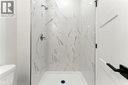 Full bath with a marble finish shower - 