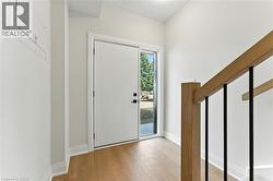 Foyer featuring light wood-style floors and baseboards - 