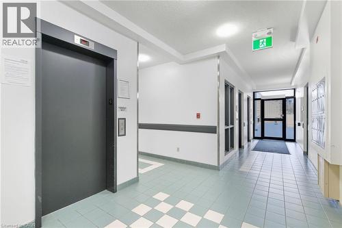 Building lobby featuring a textured ceiling - 17 King Street E Unit# 205, Dundas, ON 