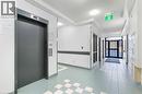 Building lobby featuring a textured ceiling - 17 King Street E Unit# 205, Dundas, ON 