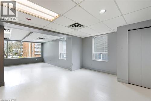 Spare room with a drop ceiling and light wood-style flooring - 17 King Street E Unit# 205, Dundas, ON 