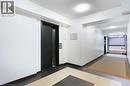 Hall with elevator, a textured ceiling, and tile patterned floors - 17 King Street E Unit# 205, Dundas, ON 