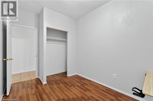 Unfurnished bedroom with wood-style flooring, a closet - 111 Hillyard Street, Hamilton, ON - Indoor Photo Showing Other Room
