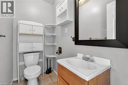 Half bath featuring vanity and light tile patterned flooring - 