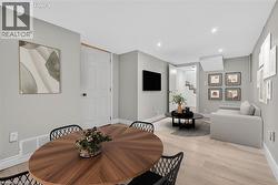 Dining area with light wood finished floors, stairway, and recessed lighting - 