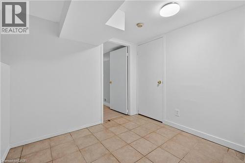 Unfurnished room featuring tile floor lower level - 111 Hillyard Street, Hamilton, ON - Indoor Photo Showing Other Room