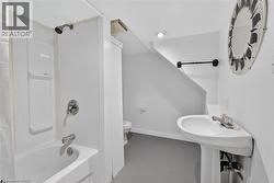Full bathroom featuring shower / bath combo and toilet - 