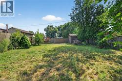 Fenced backyard with a storage unit - 