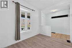 Front living room with light wood-style floors - 