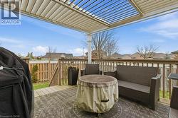 fully fenced backyard with deck, pergola, and hot tub - 