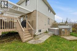 fully fenced backyard with deck, pergola, and hot tub - 