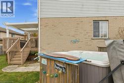 fully fenced backyard with deck, pergola, and hot tub - 