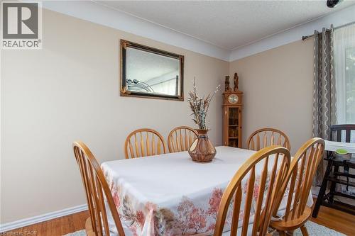Dining space with wood finished floors and a textured ceiling - 129 River Road E, Kitchener, ON - Indoor Photo Showing Dining Room