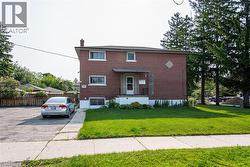 View of front of property with brick siding and a chimney - 