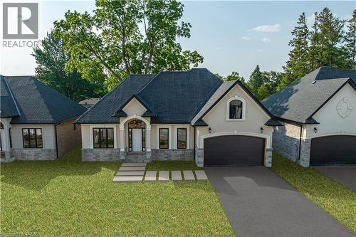 French country style house with stucco siding, stone siding, driveway, a front lawn, and a garage - 57 Cesar Place, Ancaster, ON - Outdoor With Facade