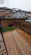 Wooden terrace featuring a fenced backyard - 